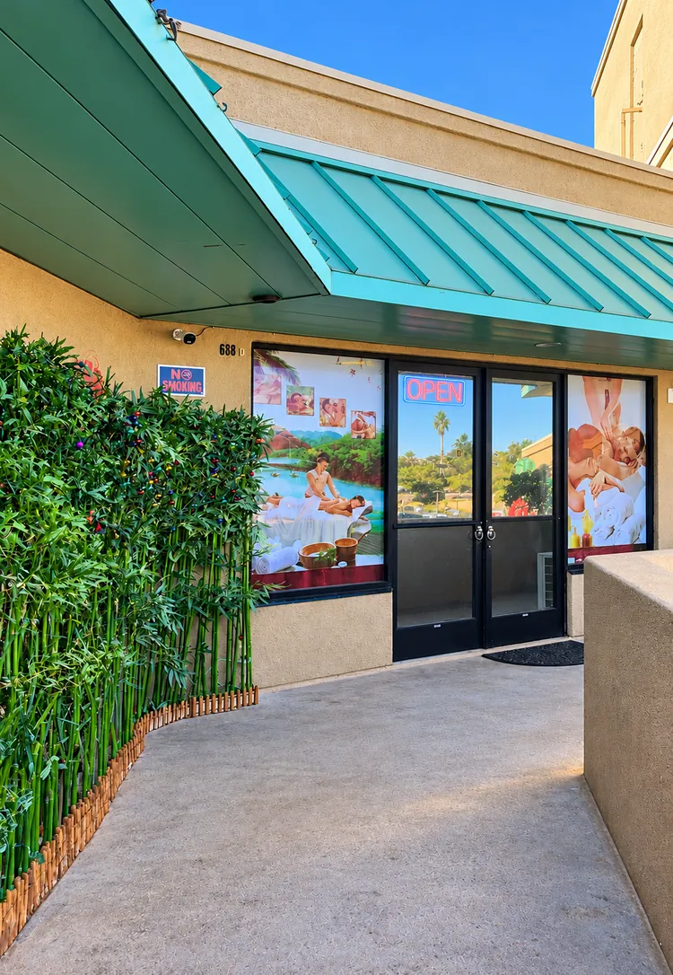 Glass front doors of Pink One SPA, suite 688 D, along the bamboo-lined walkway in San Diego, CA